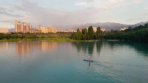 Man ride on SUP board in the mountain lake Stock Footage 204010859