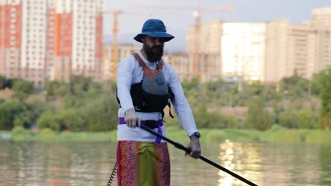Man ride on SUP board in the mountain lake Stock-Footage 204087693