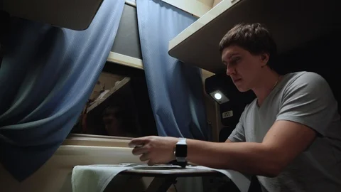 A man rides alone in a train compartment. Stock Footage 105259555
