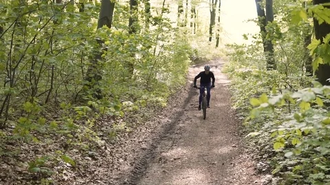 Man Rides Bicycle in the Forest 動画素材 75564162