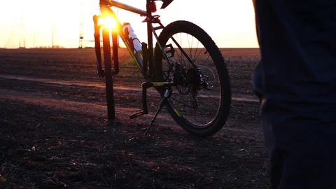 Man rides bicycle on starting for training working out. Sunset time. Stock Footage 88731869