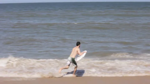 Man Rides Boogie Board Into Surf Stock Footage 37726748
