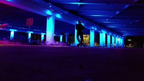 Man Rides Electric Scooter Under Colorful Bridge, San Antonio, Texas Stock Footage 146554587