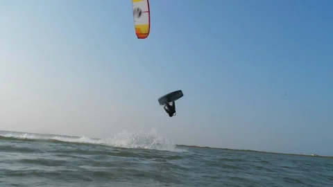 Man rides kiteboard and does Handle Pass slow motion Stock Footage 118992211