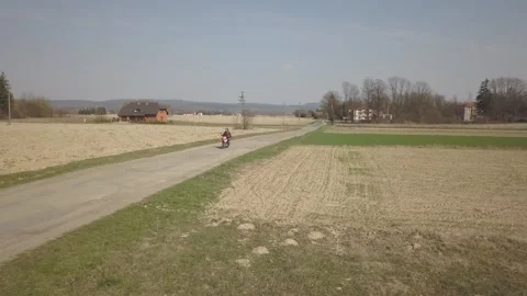 A man rides a motorcycle among the fields. Stock Footage 255828538
