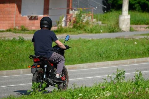 A man rides a motorcycle on the road Stock Photos