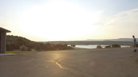 Man rides OneWheel Right to Left During Sunset HD Stock Footage 97665066