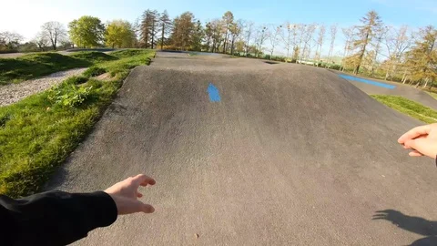 Man rides a Pumptrack on Inline Skates POV at high speed Stockbeeldmateriaal 120445404