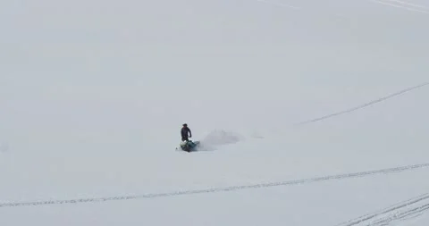 Man rides a snowmobile down the mountain slope slowly. Tuyuk-su glacier. Stock Footage 145255899
