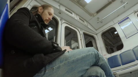 Man rides on the subway in empty carriage 動画素材 153616929