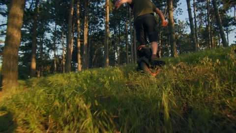 Man Rides Through Tall Grass on Electric Unicycle Stock Footage 312109239