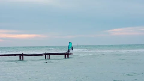 Man rides on the waves on a windsurfing board Stock Footage 160541609