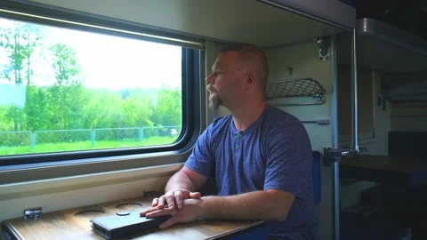 A man rides by the window on a train Stock Footage 156598174