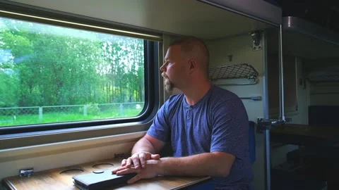 A man rides by the window on a train Stock Footage 157064761