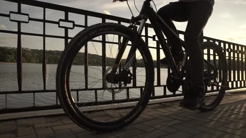 Man riding the bicycle on the bridge Stock Footage 130473007