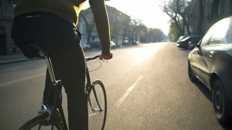 Man riding a bicycle on the empty road slow motion Stock Footage 62401998