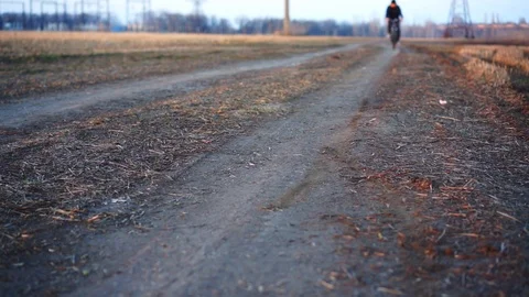 Man riding bicycle in field. Stock Footage 88731548