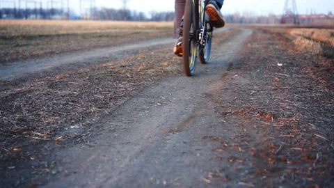 Man riding bicycle in field. Stock Footage 88731693