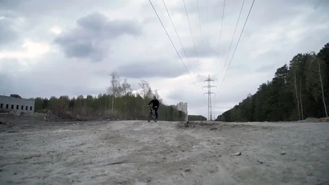 A man is riding a bicycle on the road Видео 76812129
