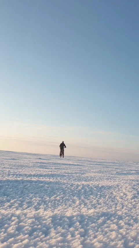 Man riding bicycle in snow in winter, solo travel Stock Footage 309881232