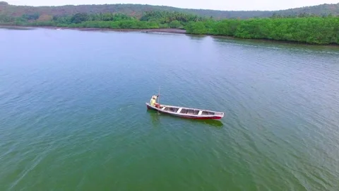 A man riding boat alone in goa Stock Footage 216512928