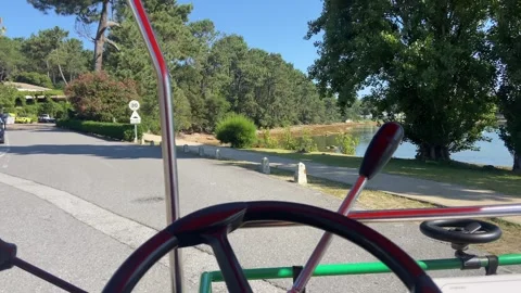 Man riding a buggy through road in sunny street of La Toja, Spain Stock Footage 250941494