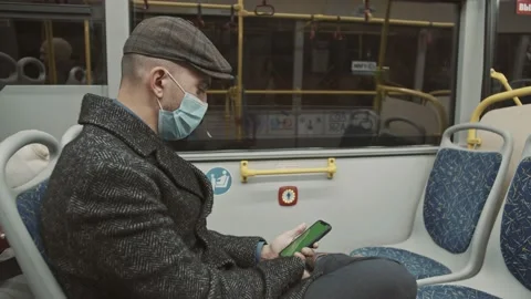 Man is riding bus and looking on screen of smartphone Stock Footage 167538367