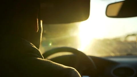A man riding on the car while driving to meet the sun Stock Footage 129639284