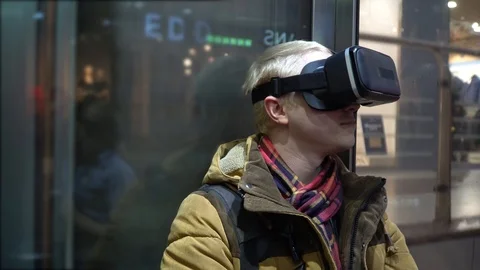 A man is riding in an elevator with virtual reality glasses Video stock 86050362