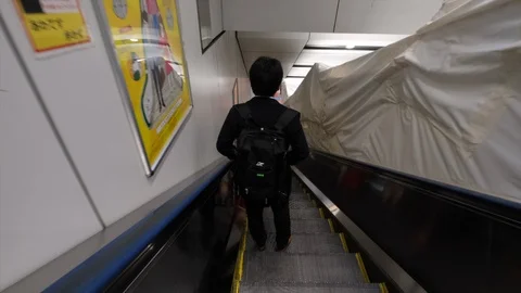 Man Riding Escalator Stock Footage 104983168