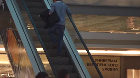 Man Riding on the Escalator at the Mall Stock Footage 61069257