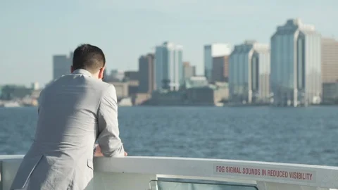 Man Riding Ferry Over Looking the Halifax Waterfront Stock Footage 91195717
