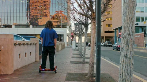 Man Riding Hoverboard in City Stock Footage 63470341