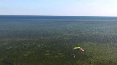 Man Riding a Kite on the Sea Stock Footage 64204212