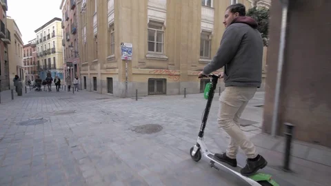 Man riding a lime s  Electric scooter Stock Footage 97498048