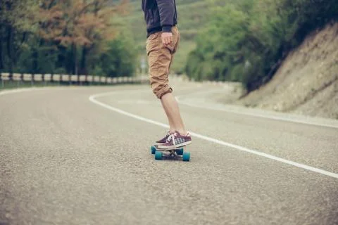 Man riding on longboard Stock Photos