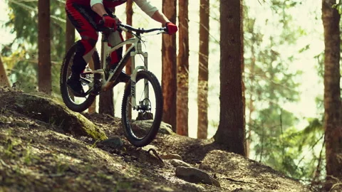 A man riding mtb down the hill in a forest in super slow motion Stock Footage 146852884