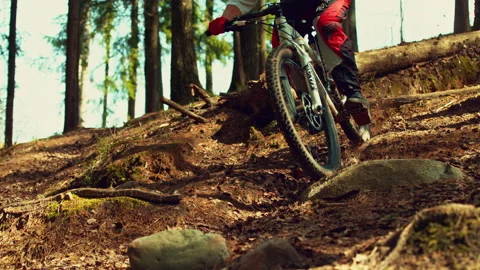 A man riding mtb down the hill in a forest in super slow motion Stock Footage 146853510