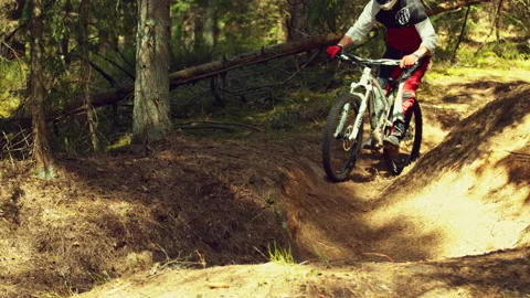 A man riding mtb down the hill in a forest in super slow motion Stock Footage 146857549