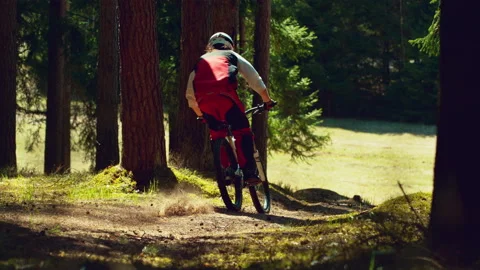 A man riding mtb down the hill in a forest in super slow motion Stock Footage 146858321