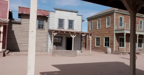Man Riding One Wheel Threw Western Movie Set Stock Footage 84157003