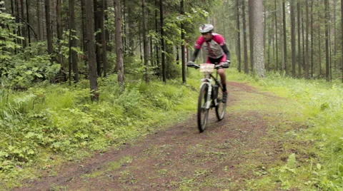 Man riding round the bend on mountain bike at Cross Country championship Stock Footage 52999887