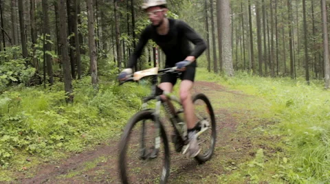 Man riding round the bend on mountain bike at Cross Country championship Stock Footage 52999967