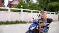 Man Riding Scooter with a Dog. Funny Video. HD Footage