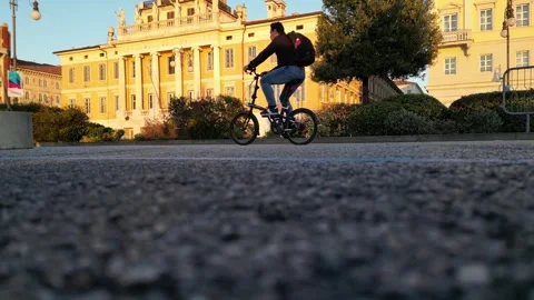Man riding a small folding bicycle on a bike lane italy Stock Footage 295520664