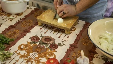 A man with a ring cutting onion 写真素材