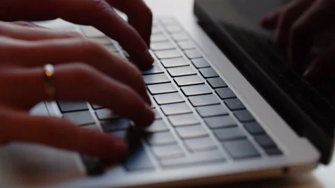 A man with a ring on his ring finger is typing on a computer keyboard. Close Stock Footage 236772213