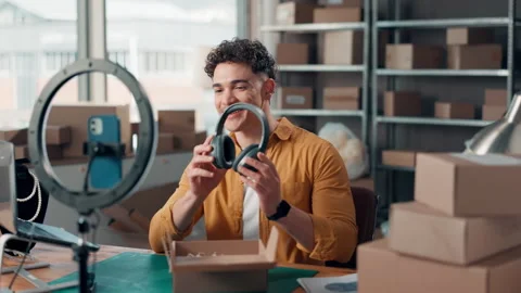 Man, ring light and filming with headphones of small business, review product Stock Footage 314789132