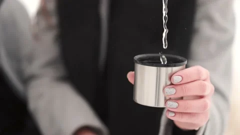 Man with ring pouring tea from thermos in a cup Stock Footage 148182876