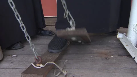 The man is ringing big and small bells in the church. Just his legs. Sound. Stock Footage 94921349